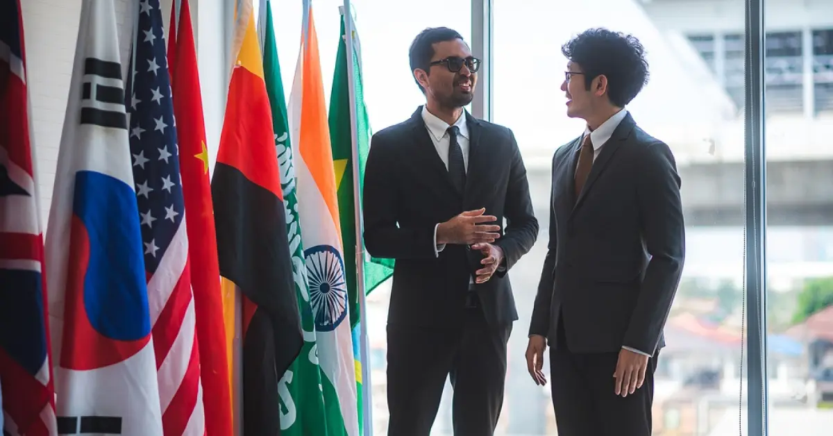 Building Strong International Business Relationships -- Two standing man discussing business