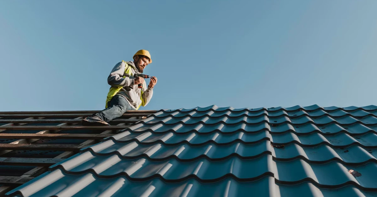 A roofer building the roof