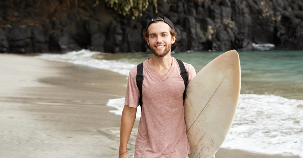 Man carrying a surfboard
