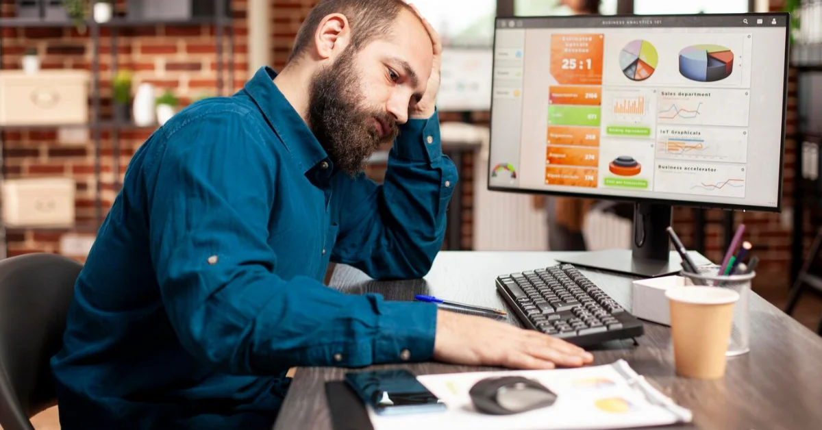 Exhausted businessman holds his forehead