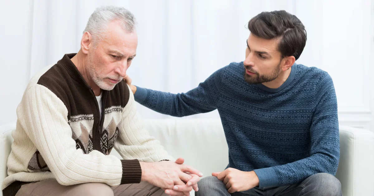 young man supporting old man