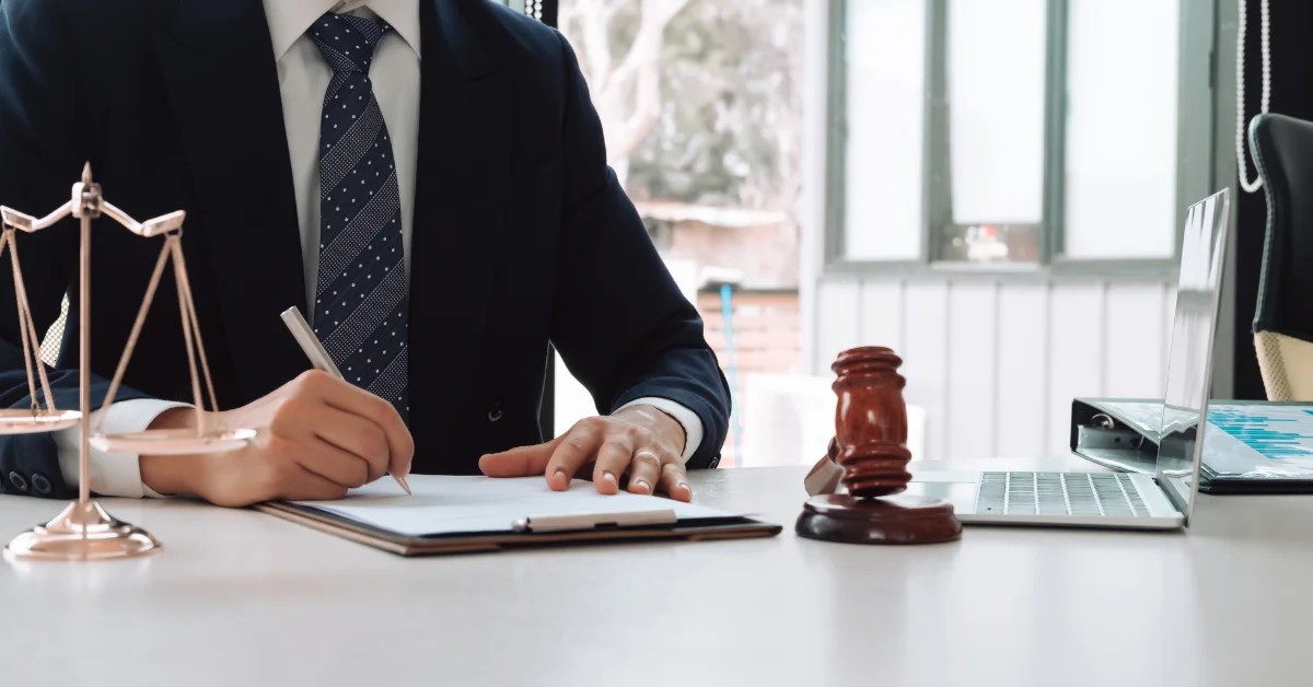 a lawyer in office, writing on a paper
