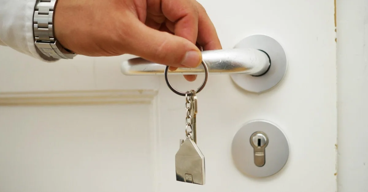 a man holding key of a house
