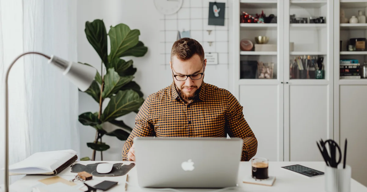 a man working on a mac in office