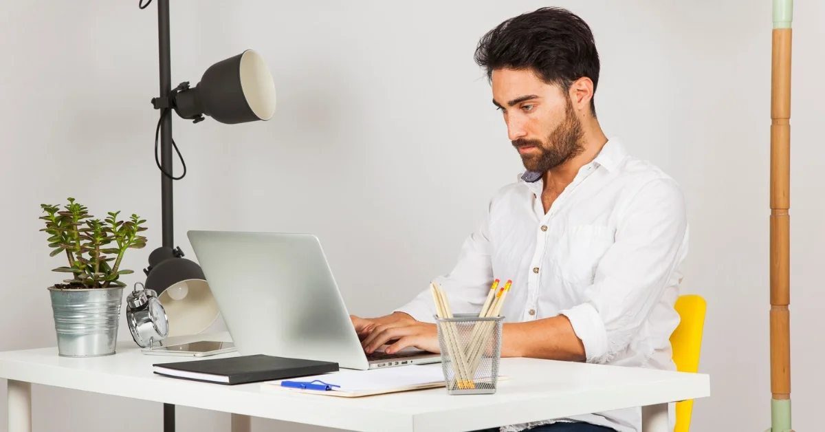 a young man working on laptop in a new office
