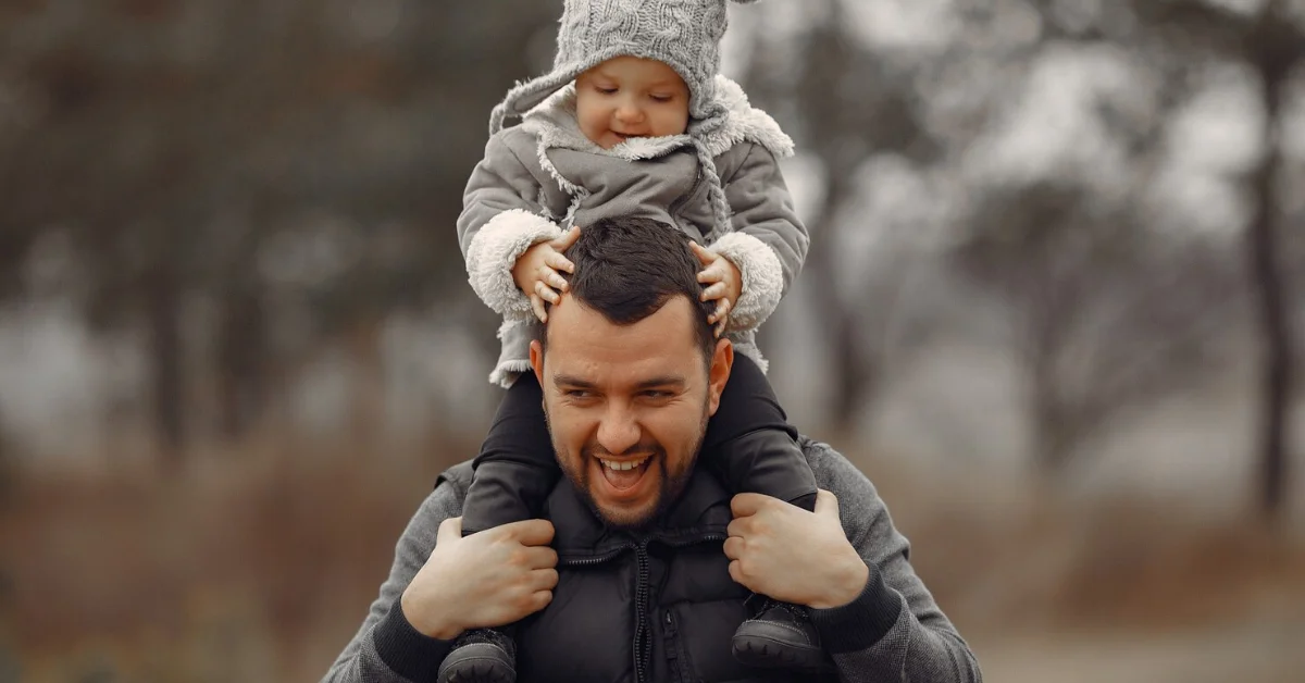 a man with a baby on his shoulders