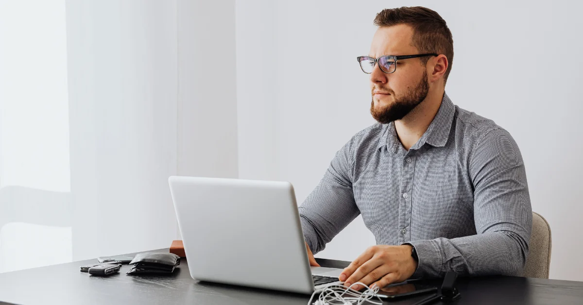 a man using laptop that's on table