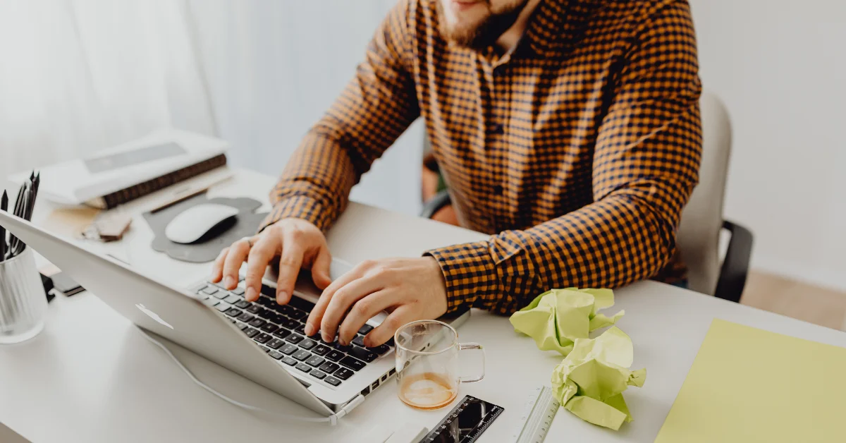 a man using macbook in office