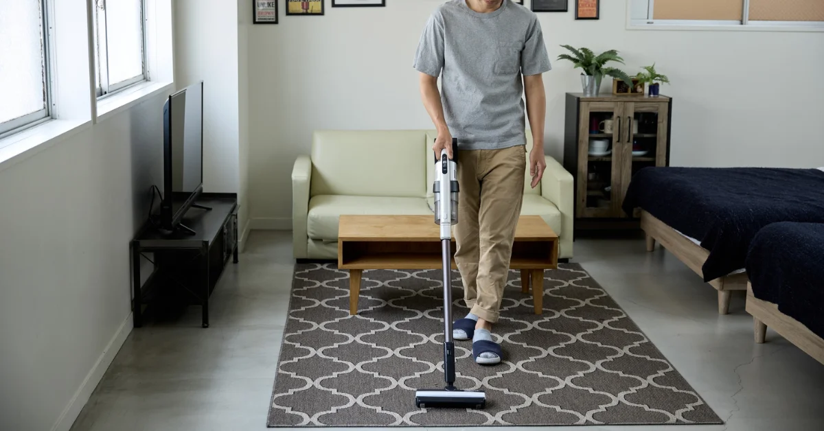 a man using vacuum cleaner
