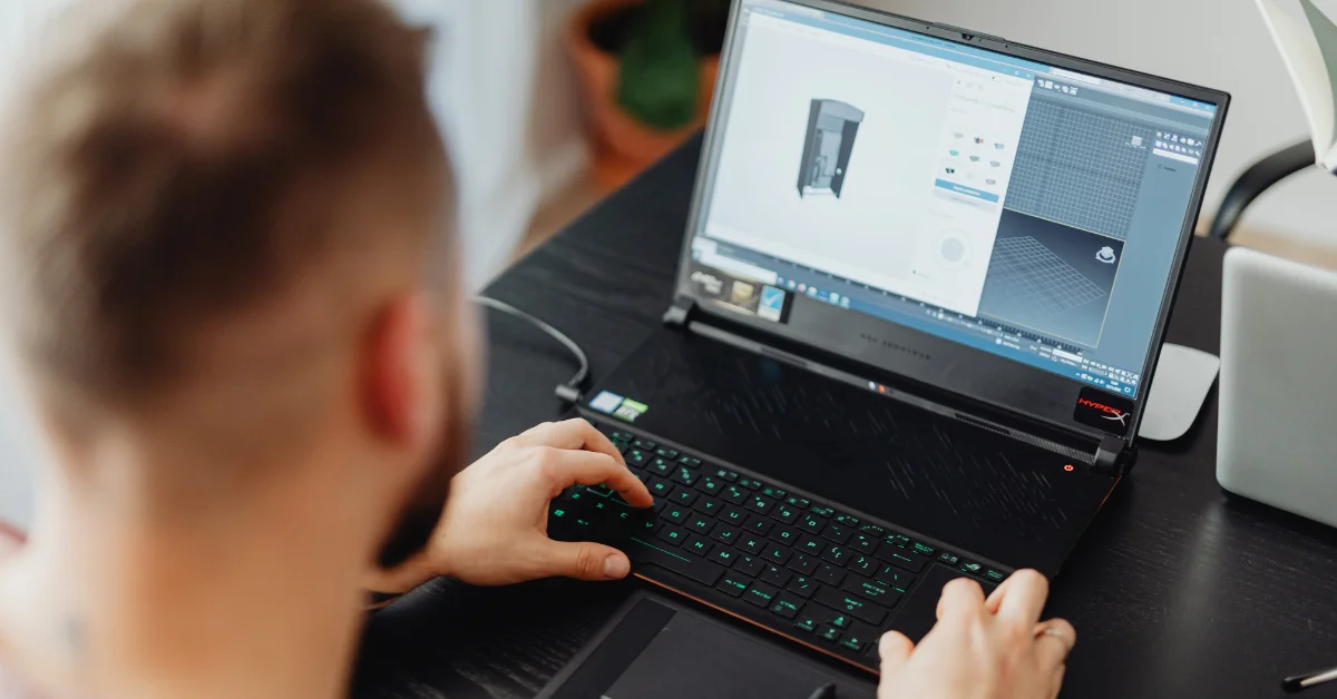 a serious man working on his laptop