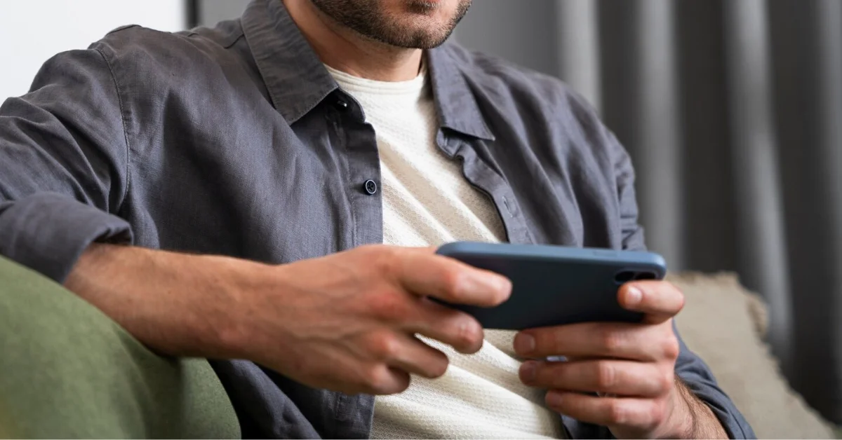 a man watching on iphone