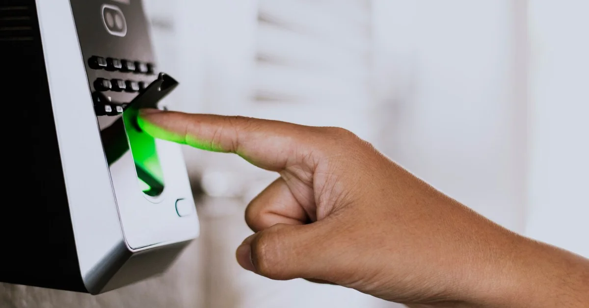 scanning finger on a fingerprint time clock