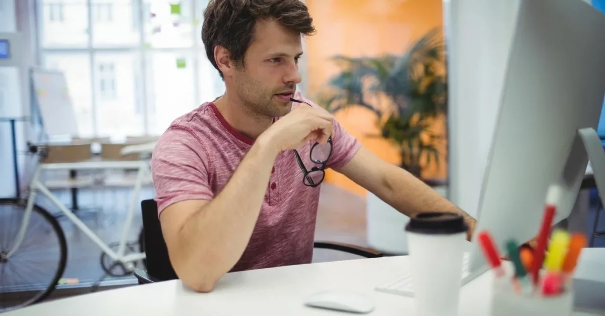 a man thinking while using computer